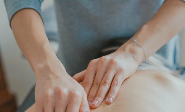 man massaging woman's body